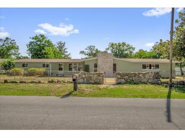 Charming single-story home with a stone accent wall and a well-maintained lawn at 1491 Granada Ave, Daytona Beach, FL 32117