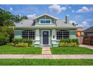 Charming green bungalow with manicured lawn, inviting entrance, and beautiful landscaping at 1625 S Eola Dr, Orlando, FL 32806
