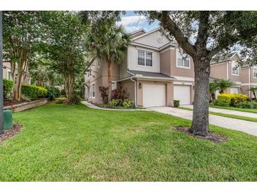 Charming townhome featuring a well-manicured lawn and two-car garage at 2110 Stockton Dr, Sanford, FL 32771