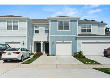 Charming light-blue townhome showcases a clean-looking garage door and well-manicured landscaping at 2949 Clever Ln, Winter Park, FL 32792