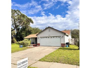 Charming single-Gathering home with attached two-car garage and well-maintained lawn at 4235 Shades Crest Ln, Sanford, FL 32773