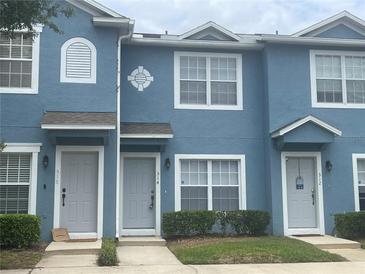 A charming blue two-story townhouse with gray trim offers inviting curb appeal at 514 Wilton Cir, Sanford, FL 32773