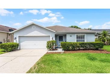 Charming single-story home featuring a well-manicured lawn, attached garage, and inviting front entrance at 520 Farmingham Ct, Oviedo, FL 32765