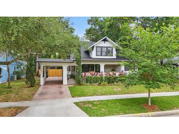 Charming home with an attached carport, lush landscaping, and eye-catching curb appeal at 641 E Livingston St, Orlando, FL 32803