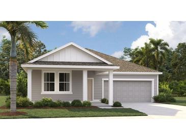 Charming single-story home boasts gray siding, complemented by well-manicured landscaping and a spacious two-car garage at 707 Junonia Blvd, New Smyrna Beach, FL 32168