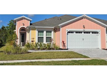 Charming single Gathering home with a two-car garage and beautifully landscaped front yard at 726 Coral Reef Way, Daytona Beach, FL 32124