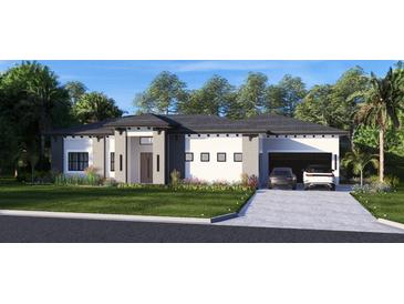 Beautiful single-story home with gray and white color scheme, manicured lawn, and a spacious two-car garage at 12818 Brunello Cir, Clermont, FL 34711