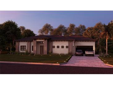 Stunning single-story home with modern elevation, manicured lawn, and a paver driveway leading to a two-car garage at 12818 Brunello Cir, Clermont, FL 34711