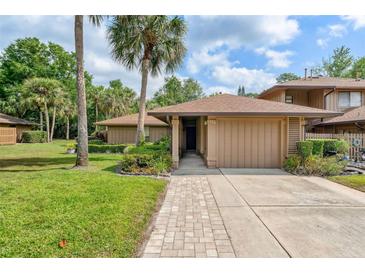 Charming home featuring mature landscaping and a brick walkway leading to the front door at 134 Heron Bay Cir, Lake Mary, FL 32746