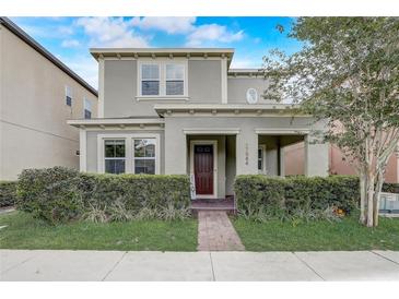 Charming two-story home with a welcoming front porch and well-manicured landscaping at 17084 Harbor Oak Pkwy, Winter Garden, FL 34787