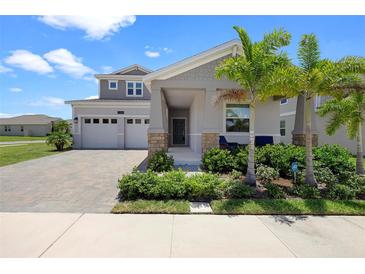 Charming two-story home with a paved driveway, landscaped yard and welcoming front porch at 2388 Volunteer Ave, Kissimmee, FL 34744