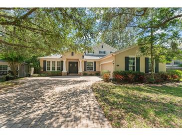 Charming home featuring brick driveway, manicured lawn, double doors and a two car garage at 2827 Park Meadow Dr, Apopka, FL 32703