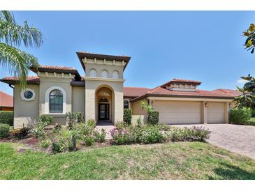 Charming single-story home with a red tile roof, manicured landscaping, and a three-car garage at 2921 Falconhill Dr, Apopka, FL 32712