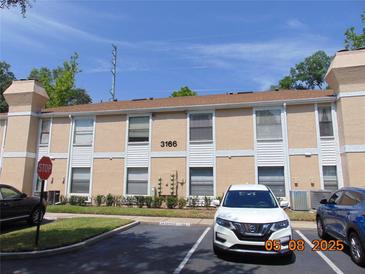 Charming condominium featuring well-maintained landscaping and reserved parking at 3166 S Semoran Blvd # 1007, Orlando, FL 32822
