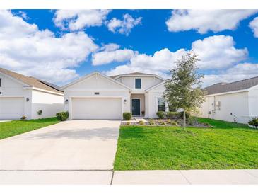 Charming single-Gathering home with a well-manicured lawn and attached two-car garage at 6984 Dilly Lake Ave, Groveland, FL 34736