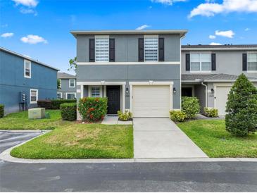 Charming two-story townhome with a one car garage and well-maintained landscaping at 12661 Somerset Oaks St, Orlando, FL 32828
