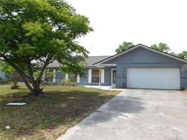Charming single-story home featuring a spacious front yard and an attached one-car garage at 130 Krider Rd, Sanford, FL 32773