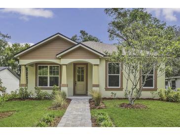 Charming single-story home featuring a well-maintained lawn, inviting entrance, and beautiful landscaping at 1371 Lake Dr, Casselberry, FL 32707