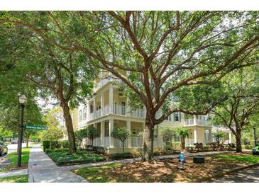 Beautiful multi-story home with multiple balconies, lush landscaping, and mature shade trees create an inviting and picturesque setting at 1630 Common Way Rd # 203, Orlando, FL 32814