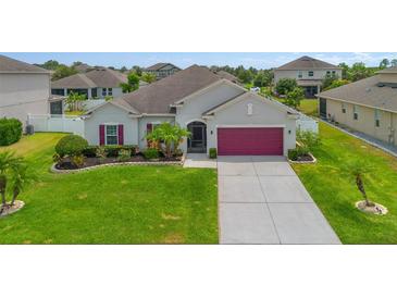 Charming single-Gathering home boasts a manicured lawn and beautiful landscaping at 2518 Hayden Valley St, Apopka, FL 32703
