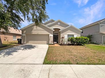 Charming single-story home featuring a well-maintained front yard and two-car garage at 5236 Shale Ridge Trl, Orlando, FL 32818
