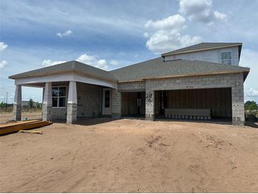 New construction home featuring a block exterior, covered porch and a spacious three car garage at 5391 Park Guell St, St Cloud, FL 34771