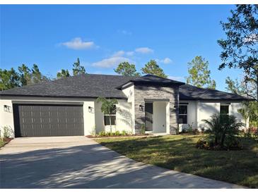 Beautiful single-story home with a modern design, gray roof, and nicely manicured lawn at 0 Overton St, Orlando, FL 32833