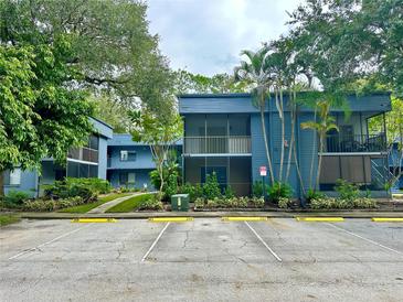 Inviting two-story condo with screened-in balconies and well-maintained landscaping at 2349 Oak Park Way # 107, Orlando, FL 32822