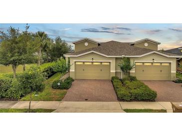 Inviting townhome featuring a brick driveway and well-maintained landscaping at 2362 Datura Loop, St Cloud, FL 34772