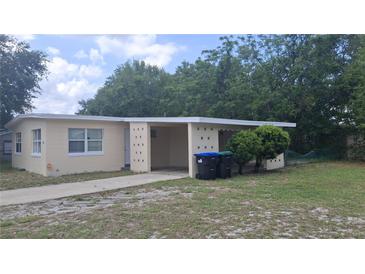 Single story home featuring neutral paint, an attached carport, and a concrete driveway at 2422 Kingsland Ave, Orlando, FL 32808
