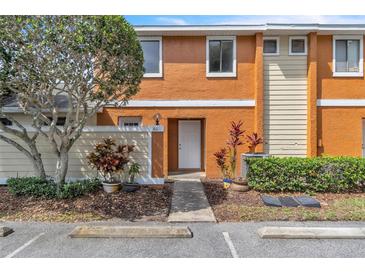 Charming townhouse with a well-maintained exterior, lush landscaping, and dedicated parking at 46 Silver Falls Cir, Kissimmee, FL 34743