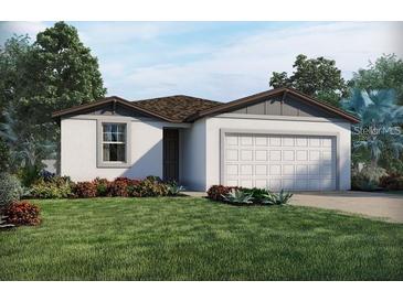 Charming single-story home featuring a two-car garage and beautifully landscaped front yard at 523 Tortugas St, Haines City, FL 33844