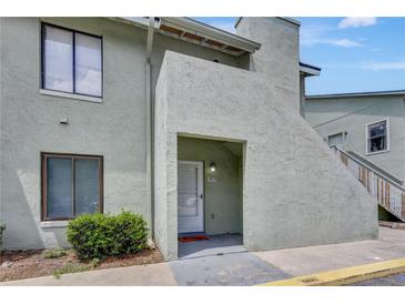 The front of a home featuring a welcoming entrance, neutral color, and neat landscaping at 5833 La Costa Dr # S, Orlando, FL 32807