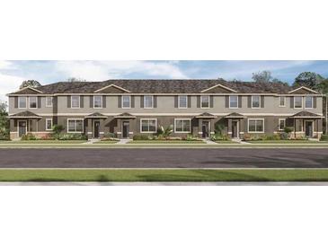 Charming townhome exterior with neutral colors, well-manicured lawn, and inviting curb appeal at 17081 Water Spring Blvd, Winter Garden, FL 34787