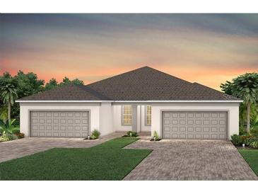 Stylish single story home with a brick paved driveway and a well-manicured green space at 5158 Gardenrow Dr, St Cloud, FL 34772