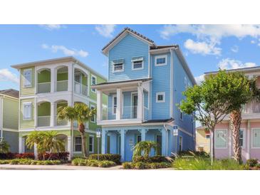 Charming three-story cottage with blue siding, white trim, and a welcoming front porch at 8045 Lost Shaker Ln, Kissimmee, FL 34747
