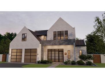 Stunning two-story modern home featuring clean lines, a brick facade and an attached two-car garage at 985 Lincoln Cir, Winter Park, FL 32789