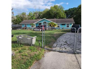 Charming single-story home with a fenced front yard and driveway at 10430 Lehman Rd, Orlando, FL 32825