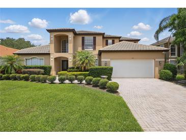 Beautiful two-story home boasts manicured landscaping, a paver driveway, and a pristine three-car garage at 108 Sagecrest Dr, Ocoee, FL 34761