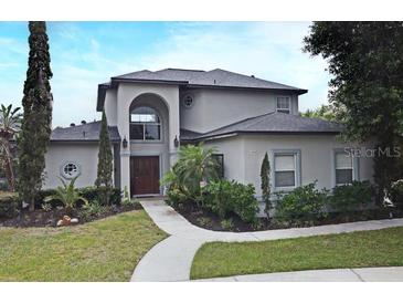 Charming two-story home with a well-manicured lawn and inviting front entrance at 11994 Mckinnon Rd, Windermere, FL 34786
