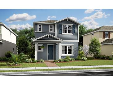 Charming two-story home with blue accents, a well-manicured lawn, and inviting curb appeal at 12536 Westhaven Oak Dr # 111, Winter Garden, FL 34787