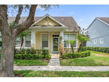 Charming yellow single-Gathering home with manicured lawn and lush landscaping at 14526 Chicora Crossing Blvd, Orlando, FL 32828