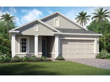 Charming one-story home featuring a two-car garage, well-manicured lawn, and stylish architectural details at 2112 Antilles Club Dr # 8, Kissimmee, FL 34747