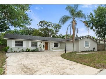 Charming single story home featuring manicured lawn and mature trees at 3520 Balsam Dr, Winter Park, FL 32792