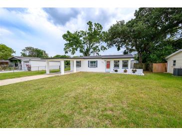 Charming single-story home with a well-manicured lawn and covered carport at 4824 Shoshone St, Orlando, FL 32819