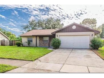 Charming home with a well-maintained front yard, attached garage and covered entry at 5311 Ansonia Ct, Orlando, FL 32839