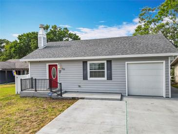 Charming single-story home features a gray exterior, red front door, and attached one car garage at 731 Guernsey St, Orlando, FL 32804