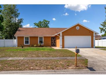 Charming single-story home with a well-manicured lawn and a two-car garage, perfect for suburban living at 7616 Southwick St, Orlando, FL 32818