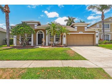 Well-maintained home with a two-car garage, beautiful landscaping, and a freshly manicured lawn at 10161 Sandy Marsh Ln, Orlando, FL 32832