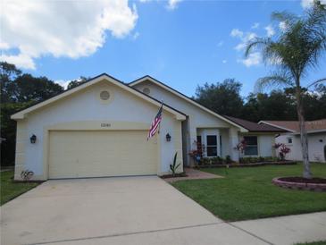 Charming single-story home featuring a two-car garage and well-maintained landscaping at 11540 Sandy Hill Dr, Orlando, FL 32821